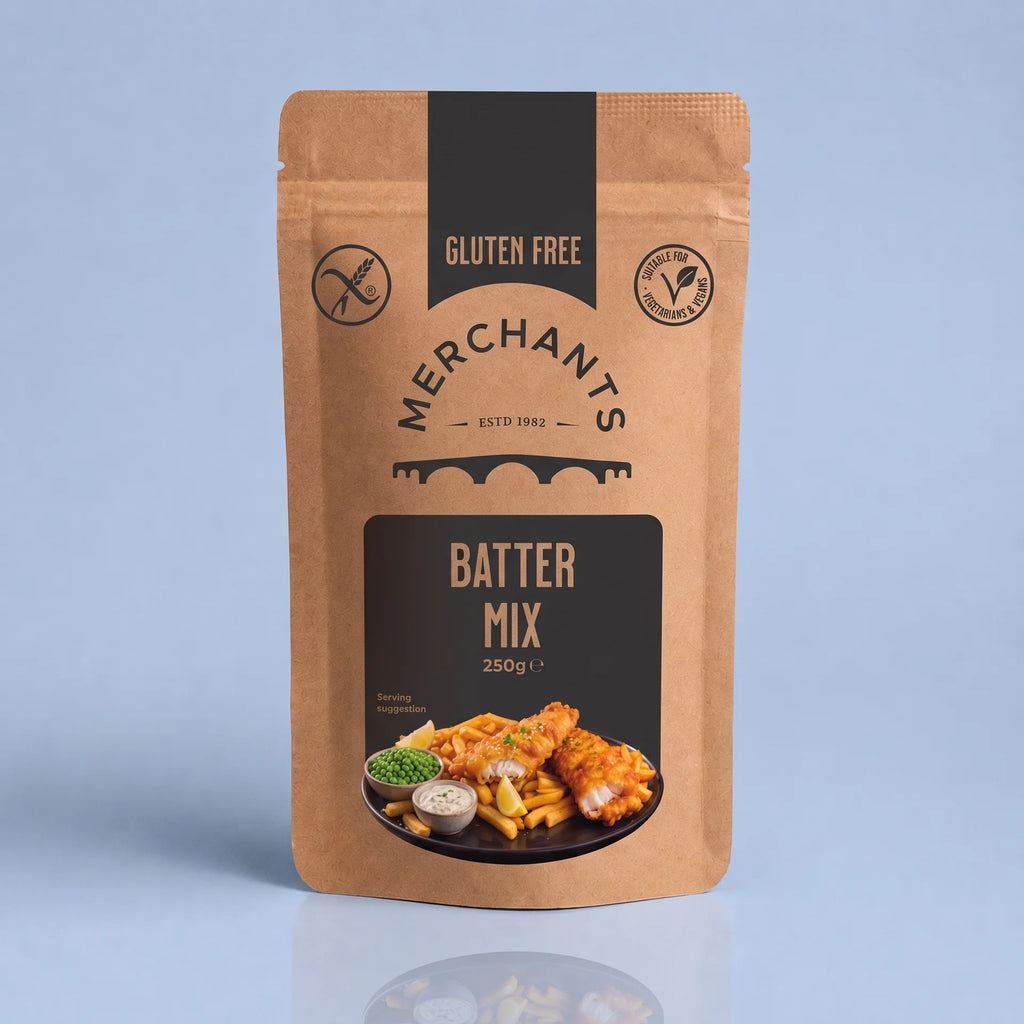 A stand-up kraft paper pouch of Merchant's Batter Mix, 250g, featuring a black and brown label with a food photo of battered fish and chips, set against a light blue background.