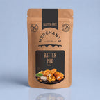 A stand-up kraft paper pouch of Merchant's Batter Mix, 250g, featuring a black and brown label with a food photo of battered fish and chips, set against a light blue background.