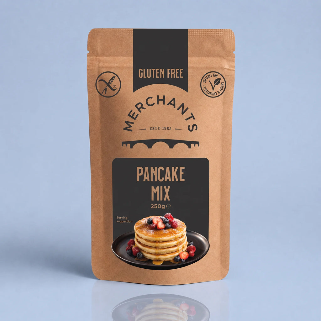 A stand-up kraft paper pouch of Merchants Pancake Mix, 250g, featuring a black and brown label with a photo of pancakes on a blue background.